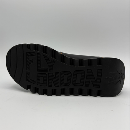 The black rubber outsole of a Fly London shoe, featuring the brand name 'FLY LONDON' embossed in large letters and a logo on the heel, shown against a light gray background.