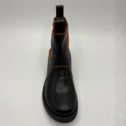 A black leather Chelsea boot with contrast orange stitching and a brown elastic side panel, shown from a top-down view on a white background.