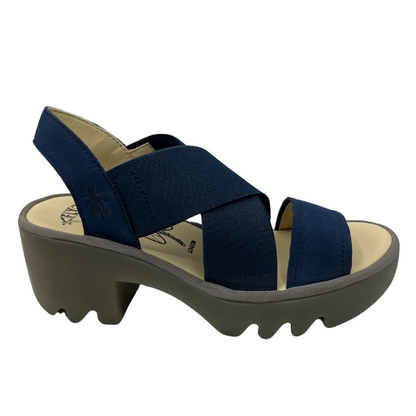 Right facing view of navy blue stretchy strapped sandal with lugged rubber outsole and rounded toe