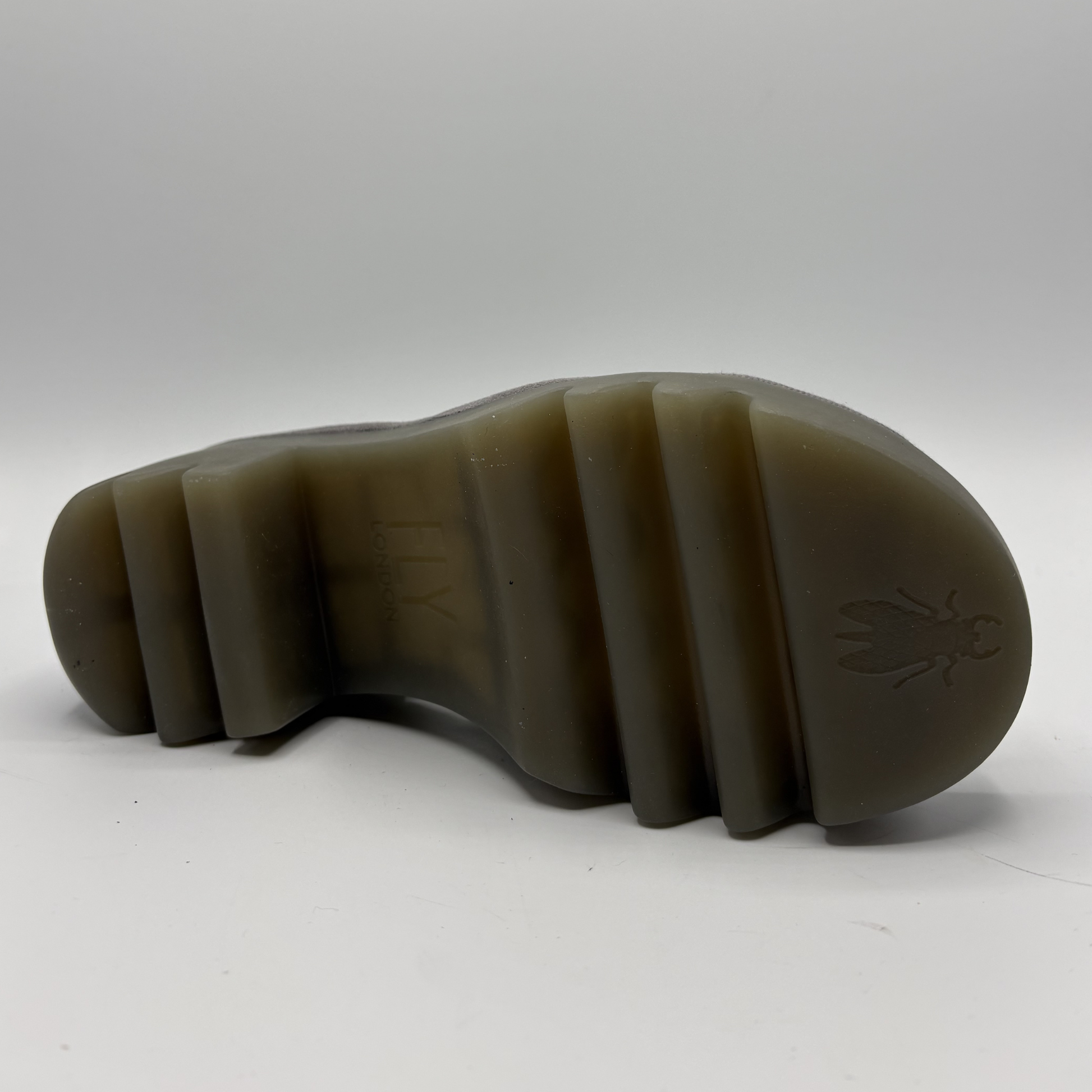 Brown sole of a shoe with a brand logo on a white background