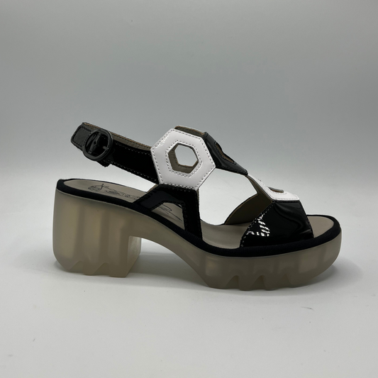 Right facing view of a black and white patent leather sandal with a lug platform sole and adjustable slingback strap.