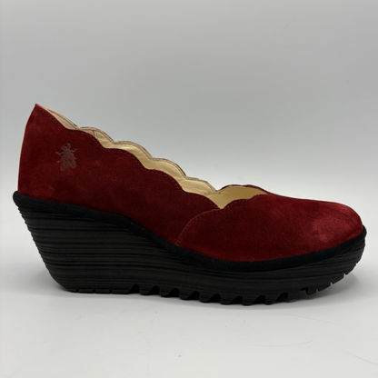 A single burgundy suede wedge shoe with a scalloped edge and a thick black treaded platform sole, shown from a side profile on a light gray background.