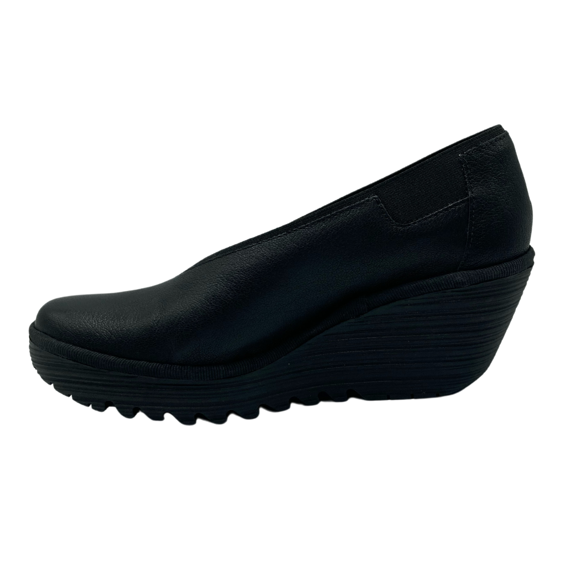 Inner side view of wedge heel with black rubber bottom