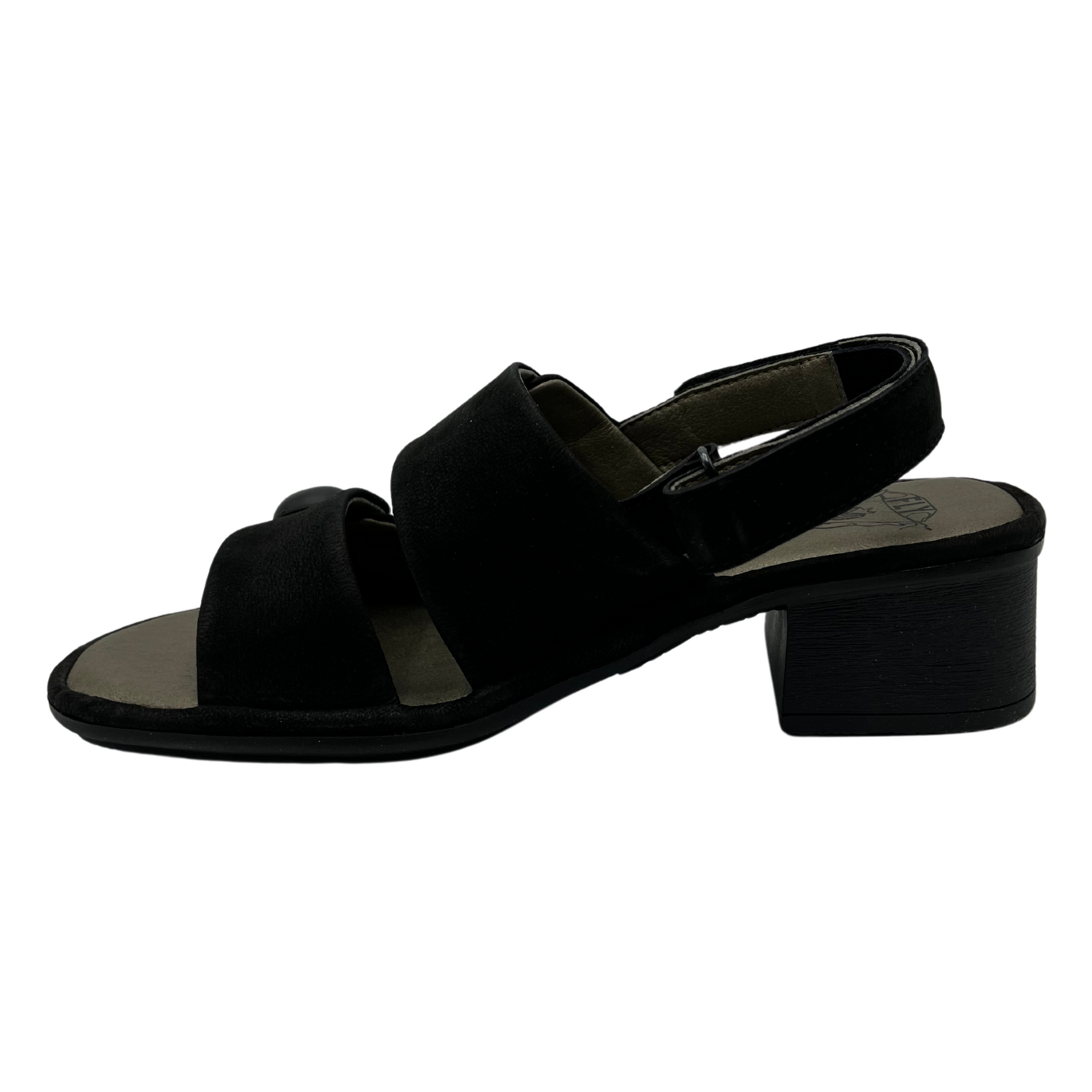 Left facing view of black leather sandal with block heel, velcro slingback strap and double straps with large buttons