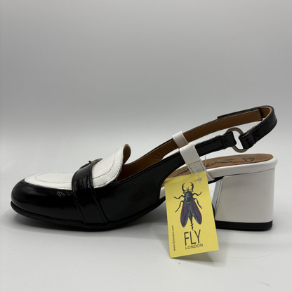 Black and white shoe with a yellow 'Fly London' tag on a gray background