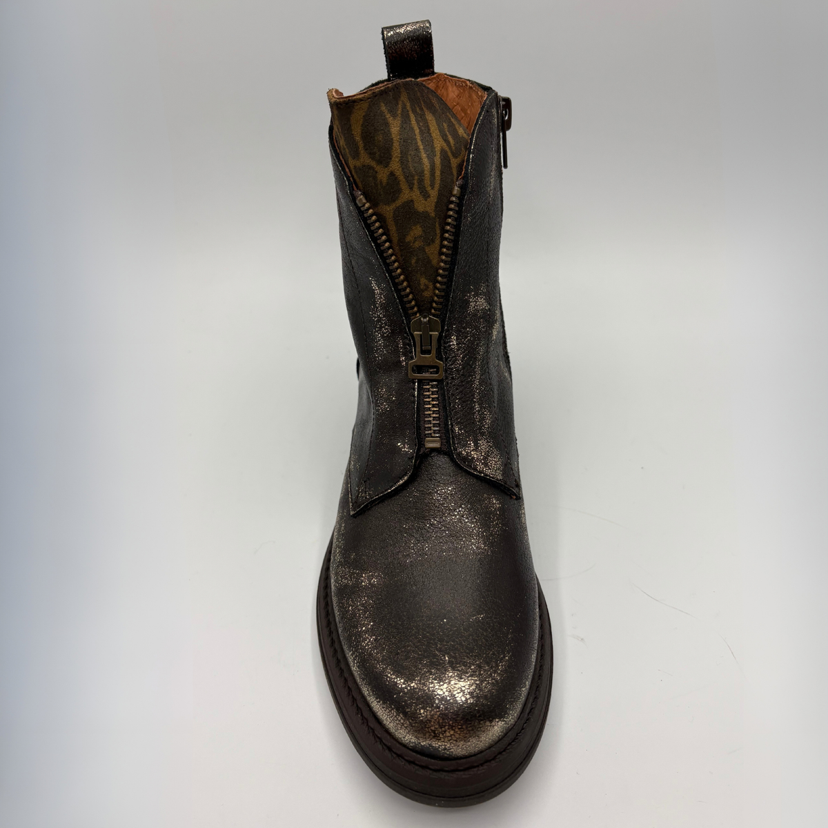 Front  view of a weather look leather boot with a leopard print tongue