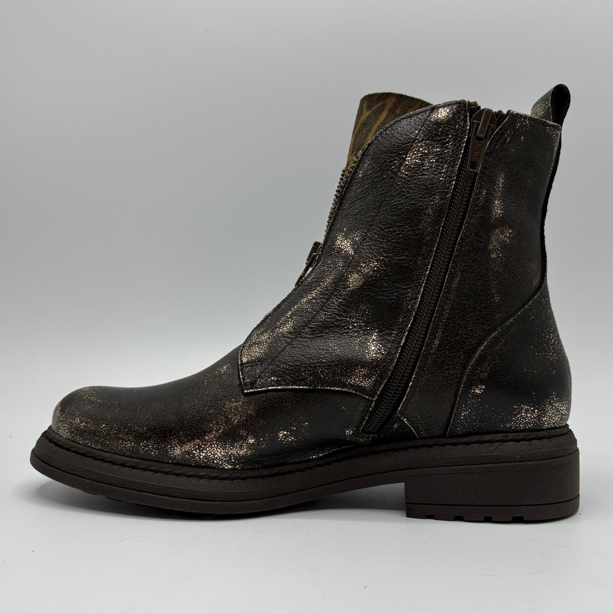 Left facing view of a weather look leather boot with a leopard print tongue