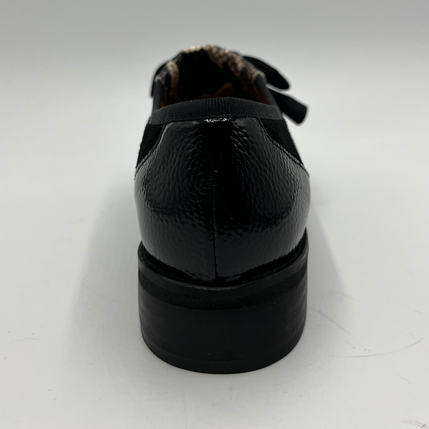 Black leather shoe on a white background
