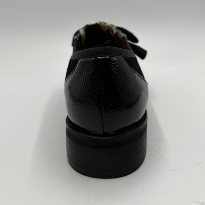 Black leather shoe on a white background