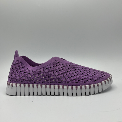 Right facing view of purple frosting coloured slip on shoe with an intricate laser cut upper and white rubber outsole.