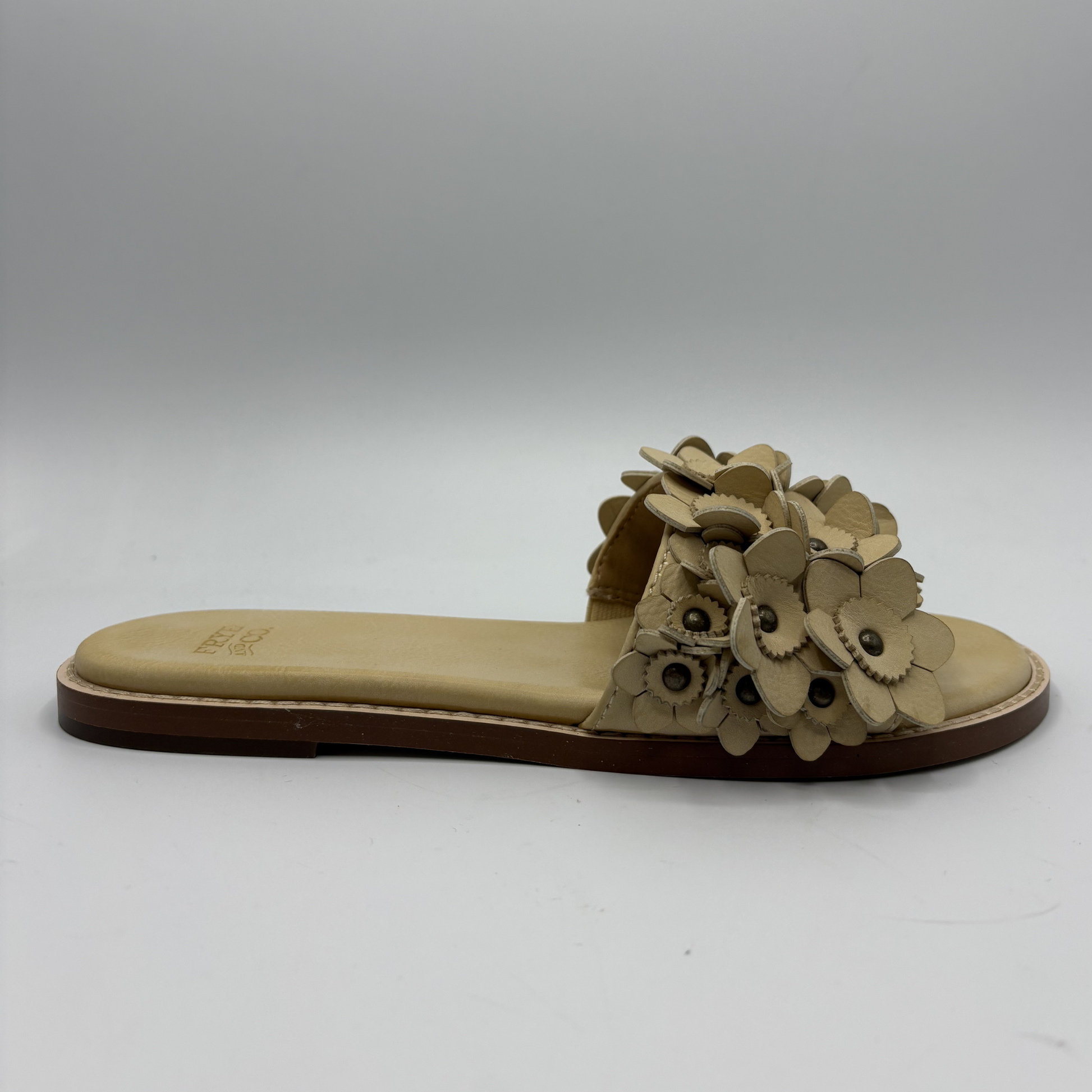 Beige sandal with floral design on a white background