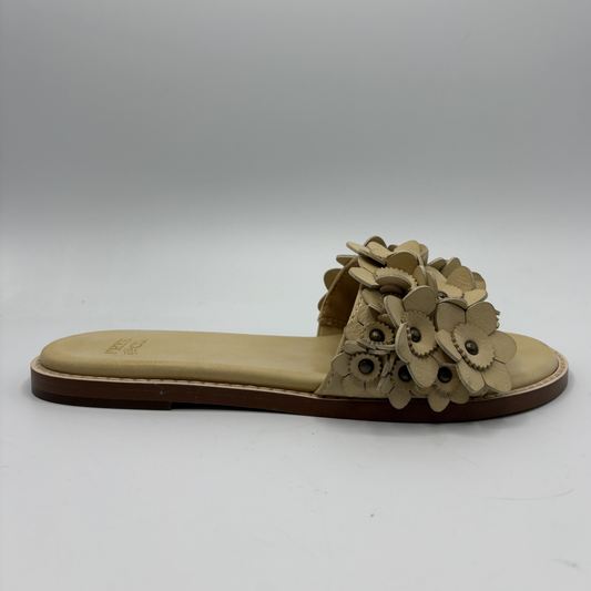 Beige sandal with floral design on a white background