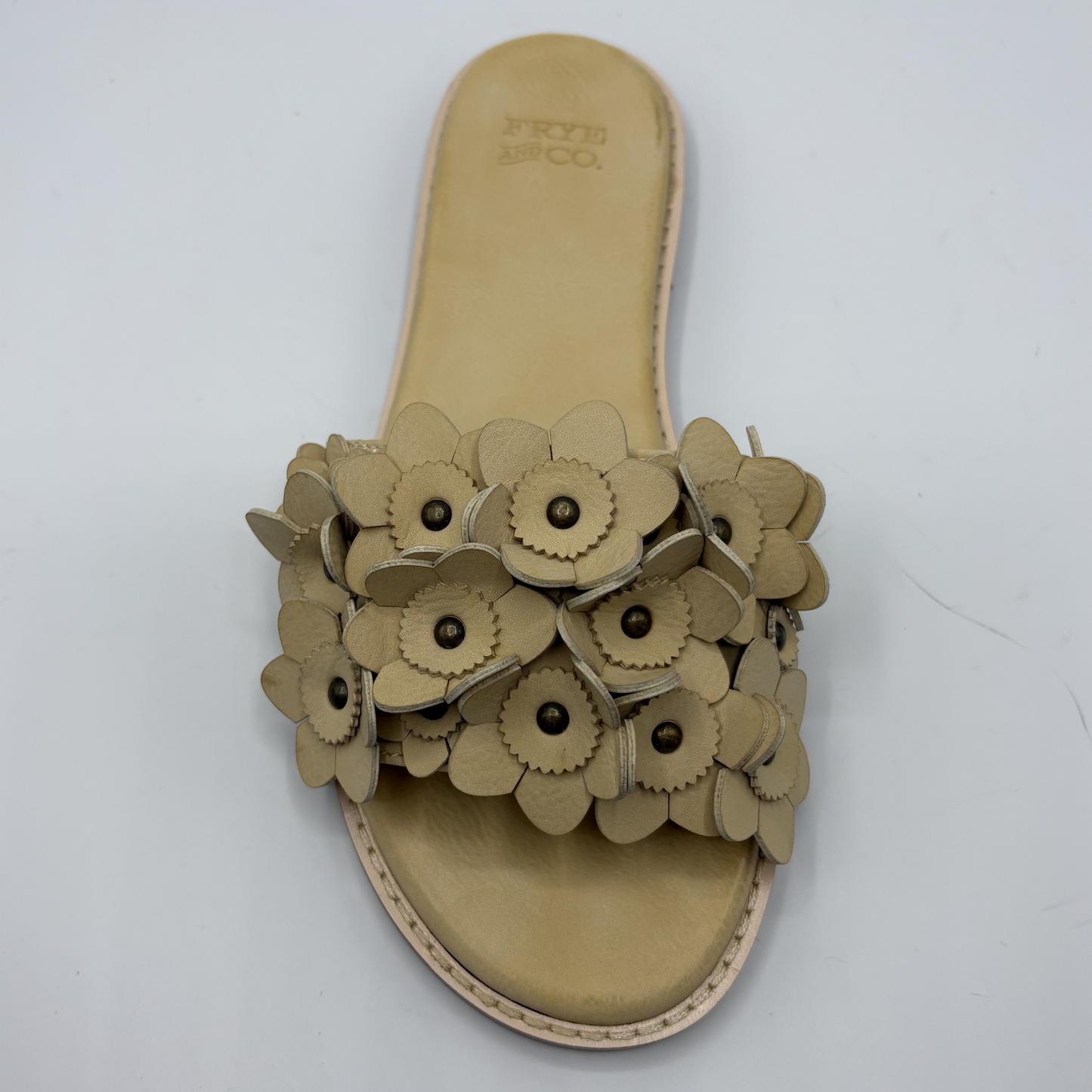 Beige sandal with floral design on a white background