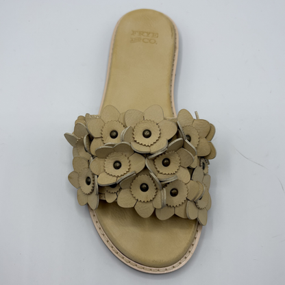 Beige sandal with floral design on a white background