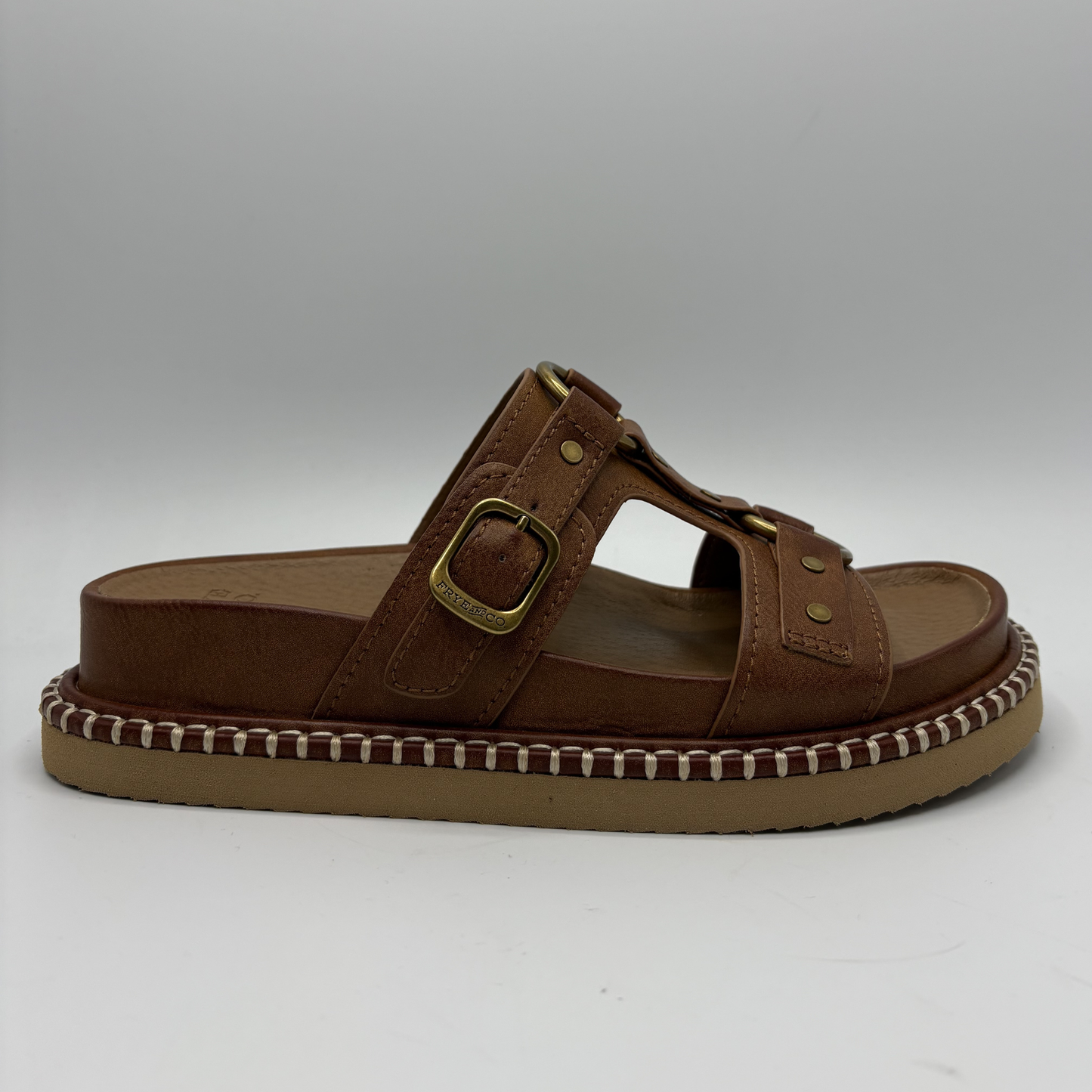 Brown sandal with a strap and buckle on a white background