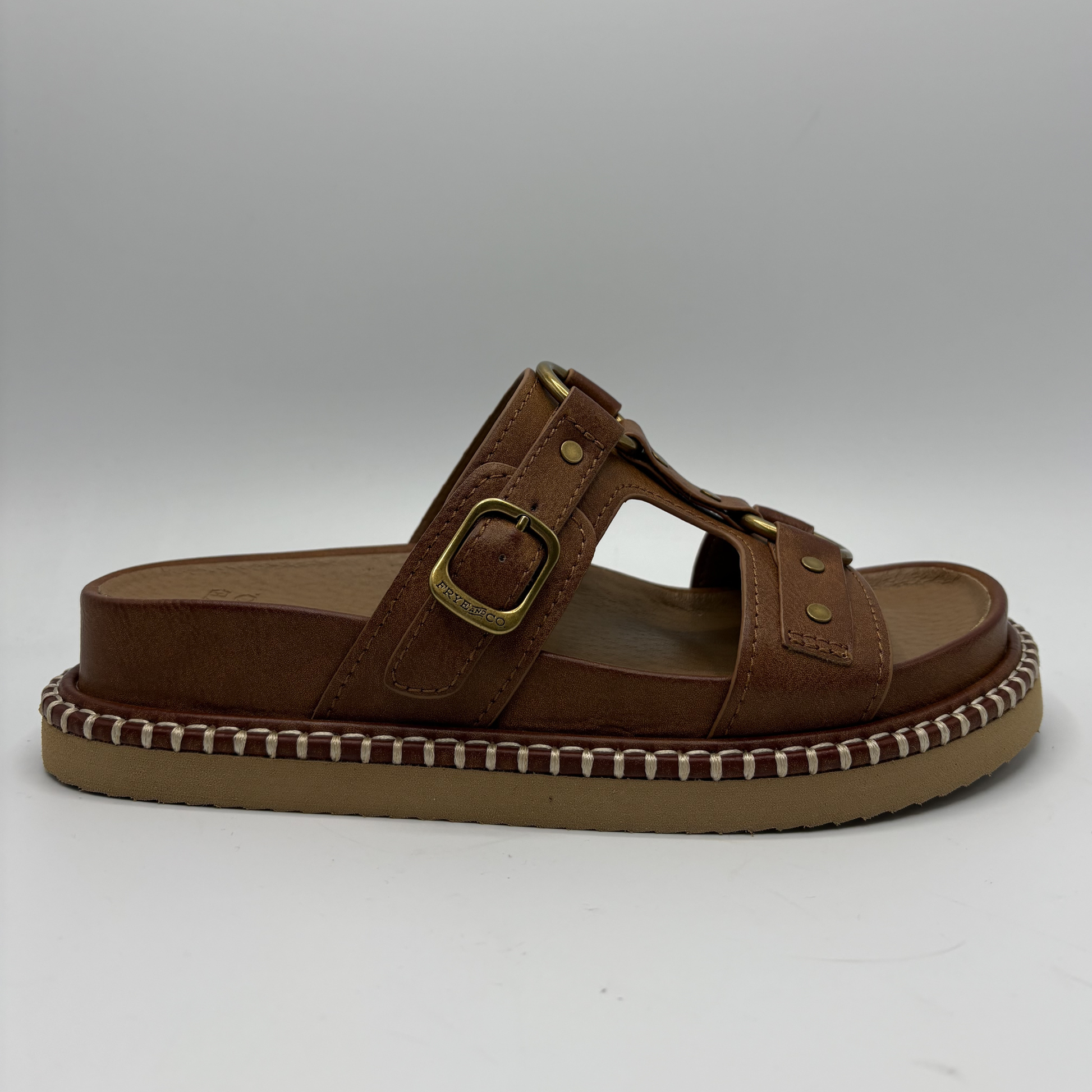 Brown sandal with a strap and buckle on a white background
