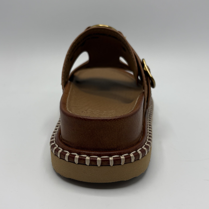 Brown sandal with a strap on a white background