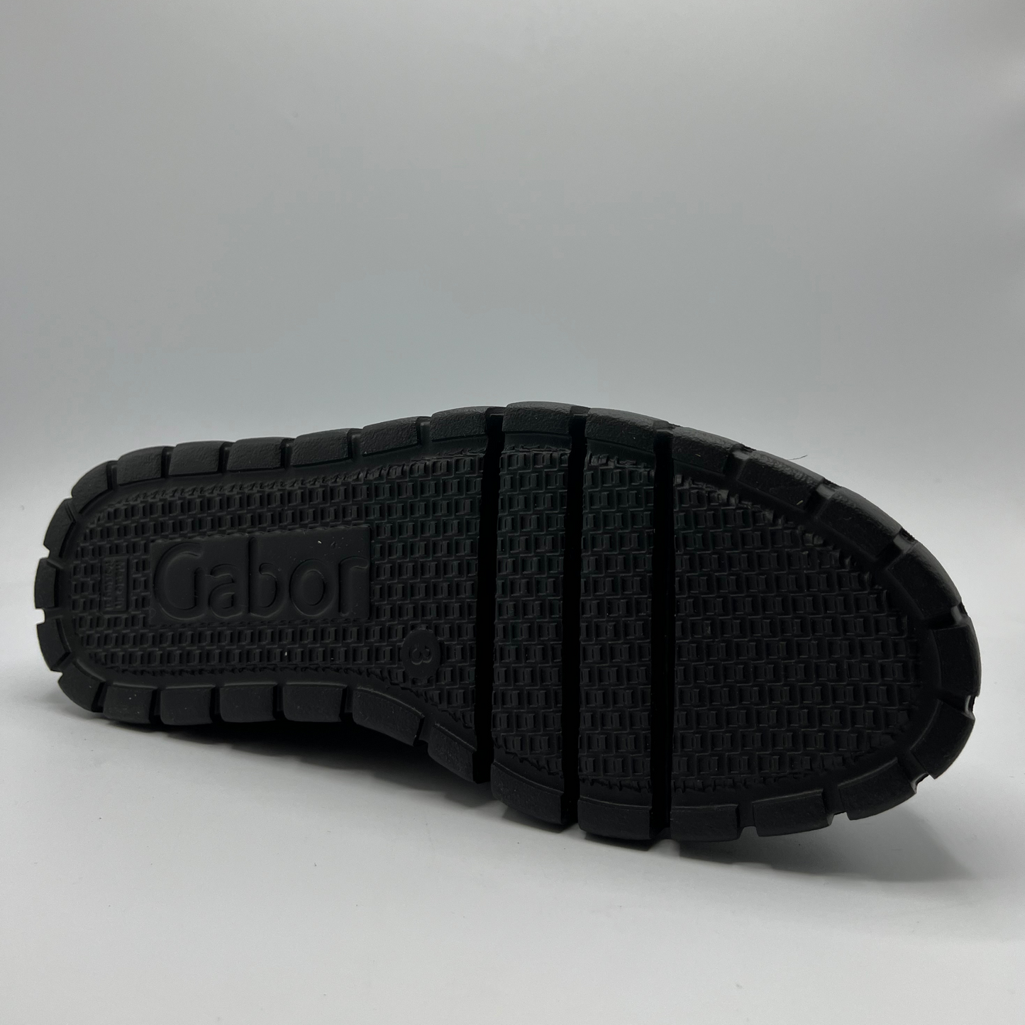 Black sole of a shoe with 'Gabor' branding on a gray background