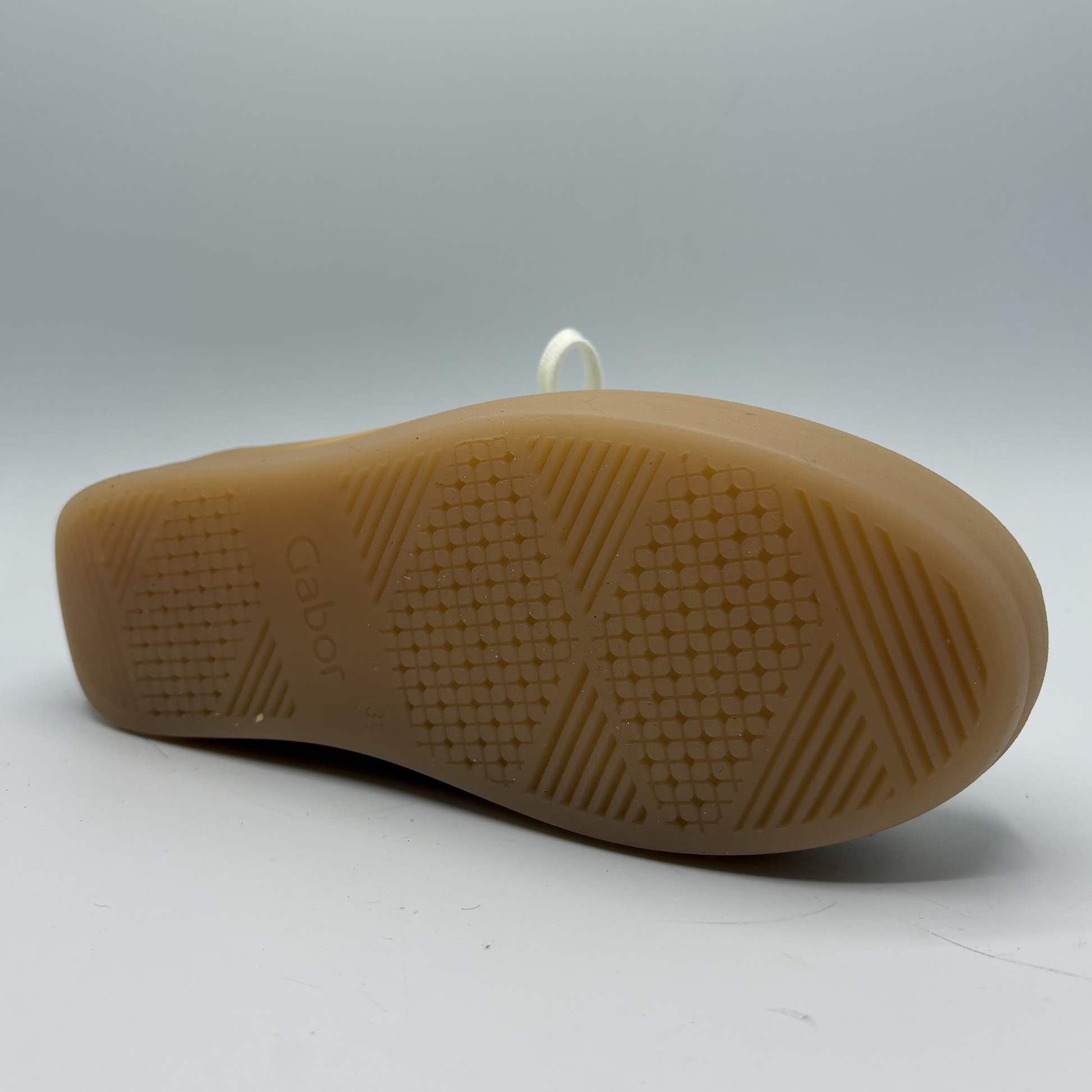 Brown sole of a shoe with 'Gabor' branding on a white background