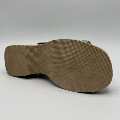 Brown sandal sole with brand logo on a white background