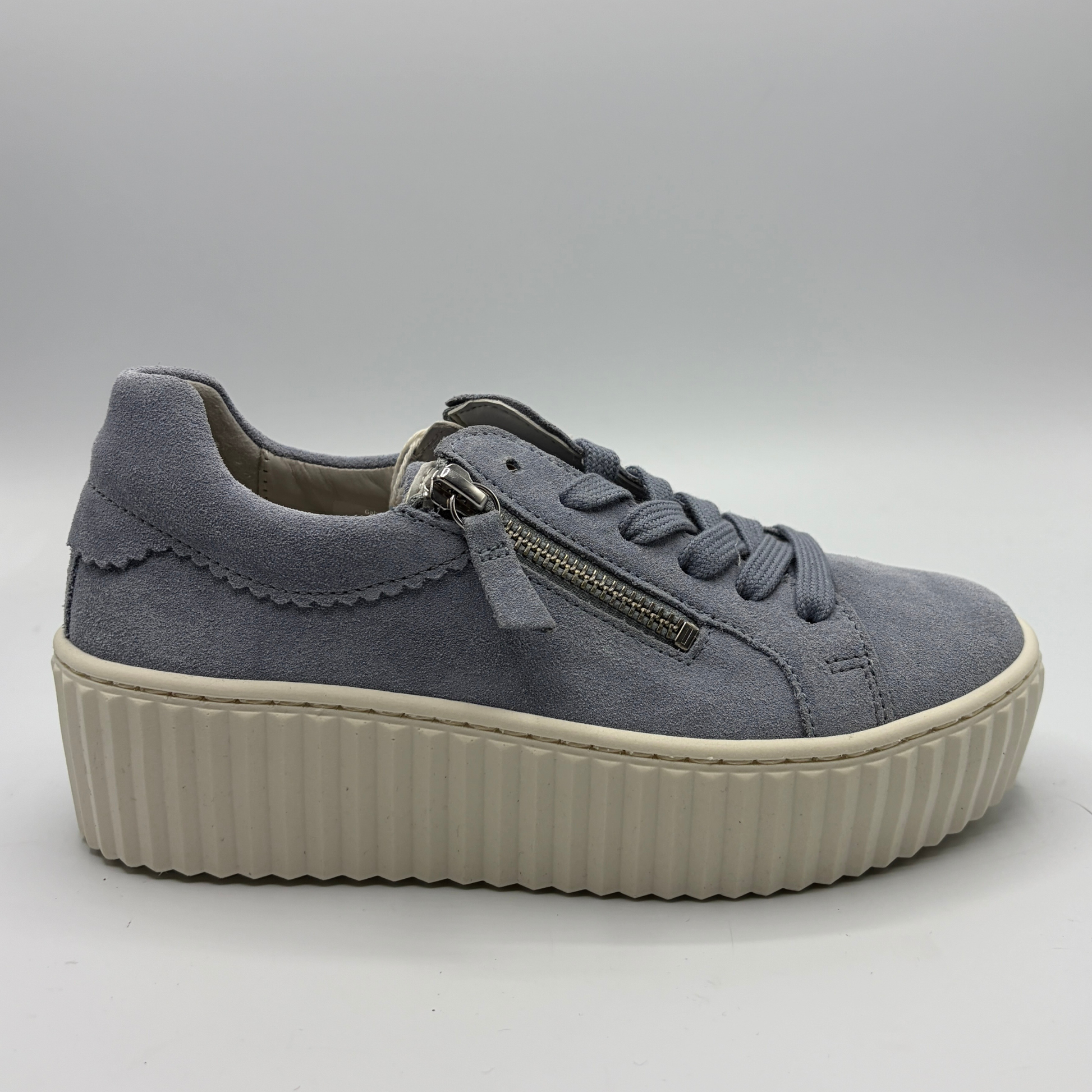 Gray sneaker with a platform sole on a light gray background
