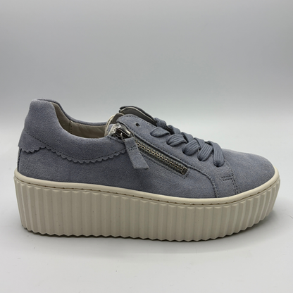 Gray sneaker with a platform sole on a light gray background