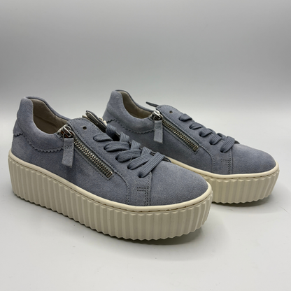 Pair of gray sneakers with zippers on a light gray background