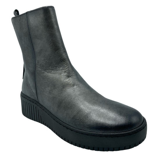 45 degree angled view of dark grey leather short boot with black platform wedge sole