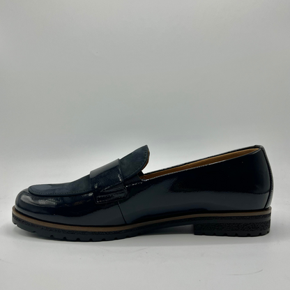 Left facing view of a black leather loafer with a tan lining
