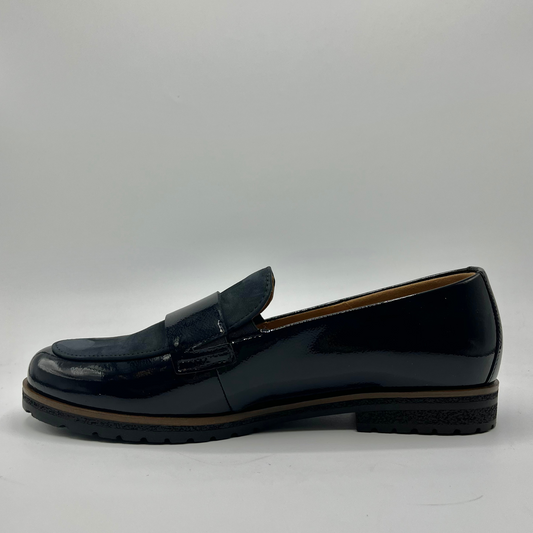 Left facing view of a black leather loafer with a tan lining
