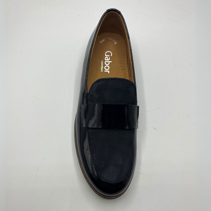 Top view of a black leather loafer with a tan lining