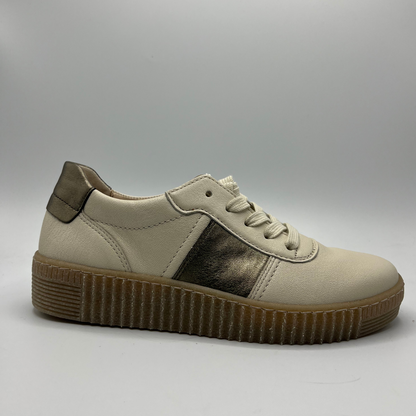 Right facing view of a beige leather shoe with metallic accents and a lace up design