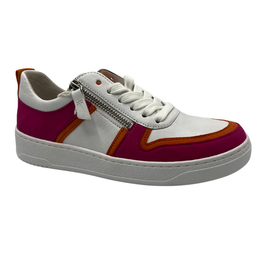 45 degree angled view of white, fuchsia and orange sneaker with white laces and rubber outsole.