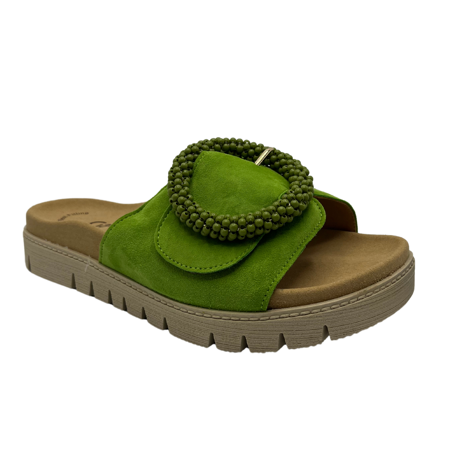 45 degree angled view of Lime green suede slide with large buckle detail and anatomical footbed