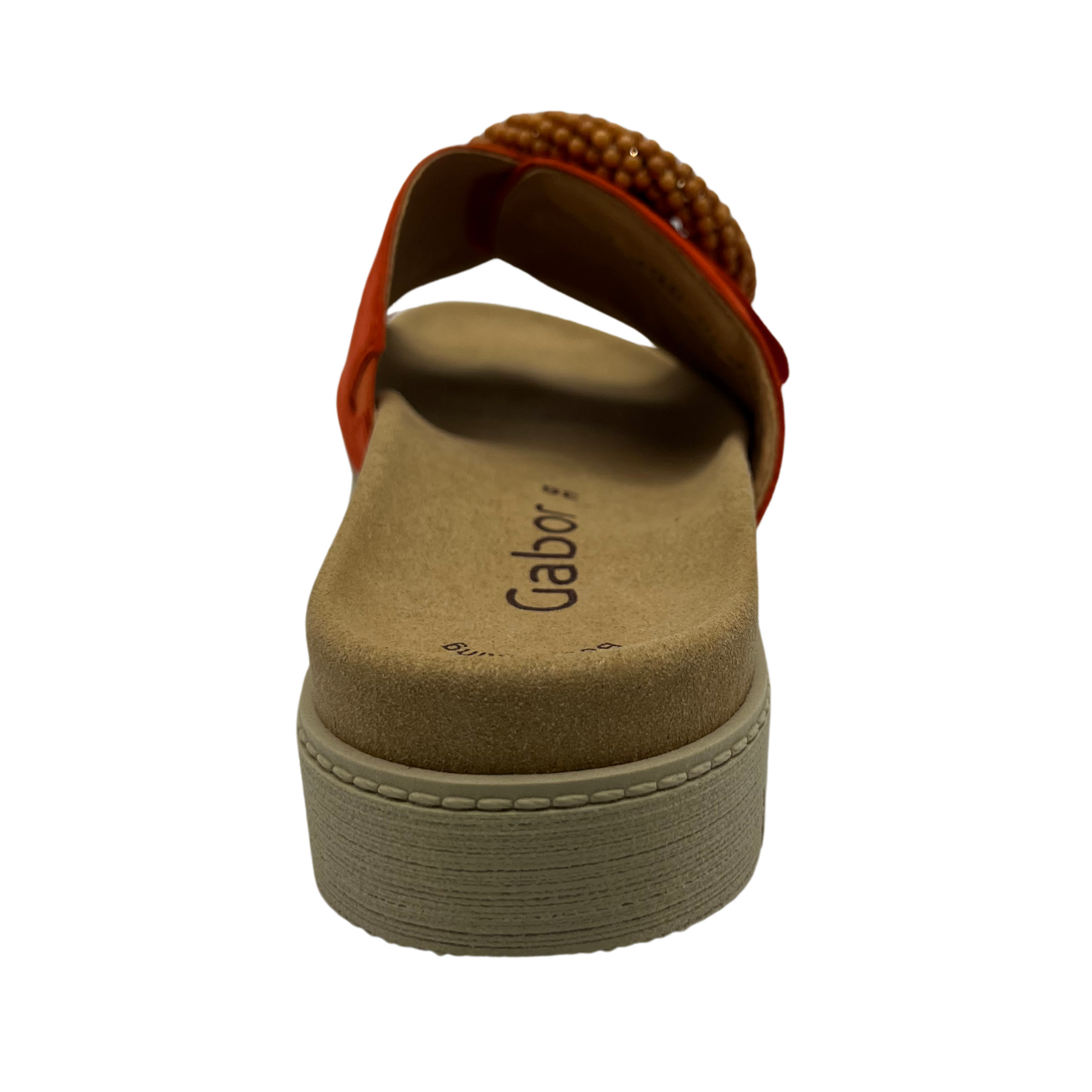 Back view of orange suede slide with large buckle detail and anatomical footbed