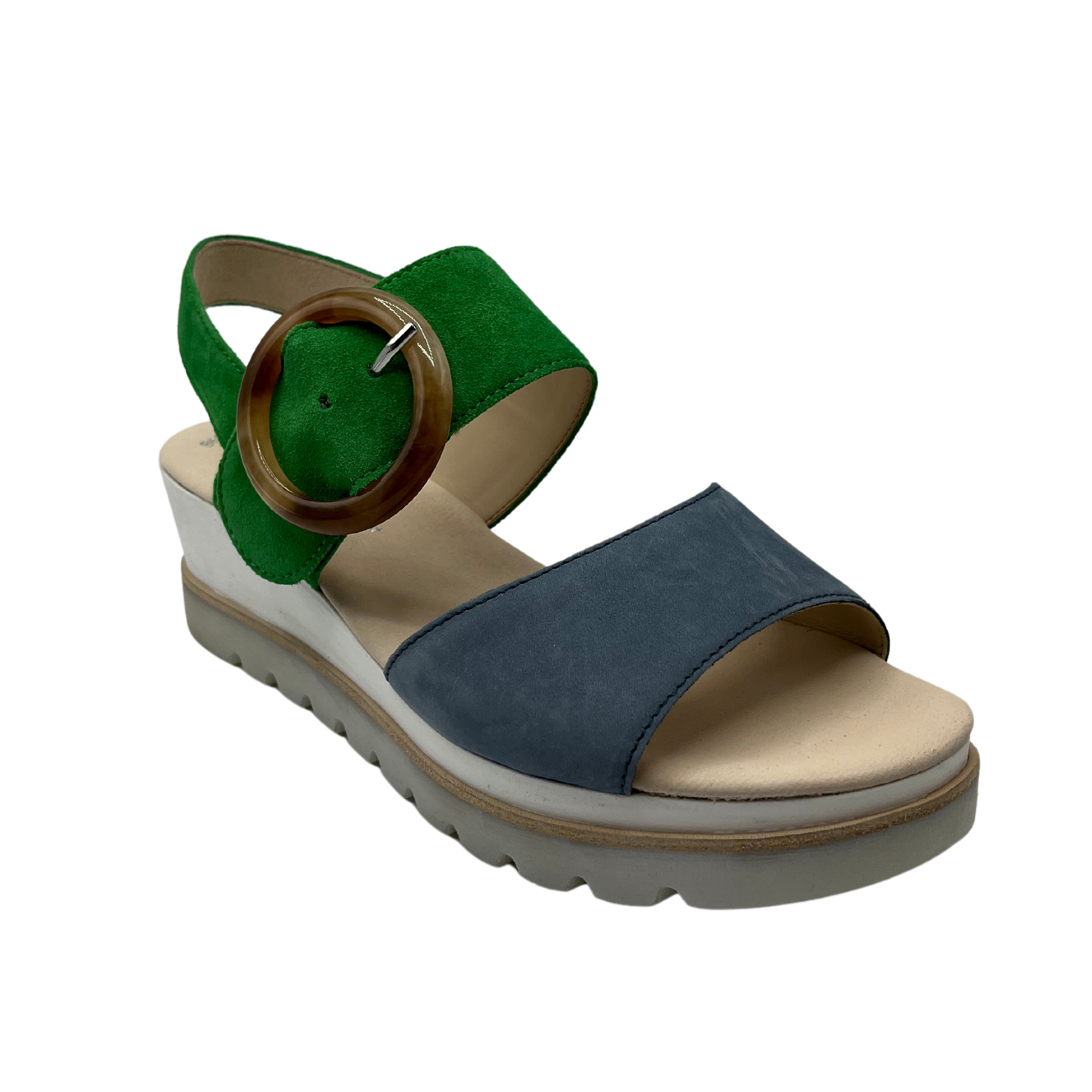 45 degree angled view of blue and green wedge heeled sandal with open toe and tortoise pattern buckle on ankle