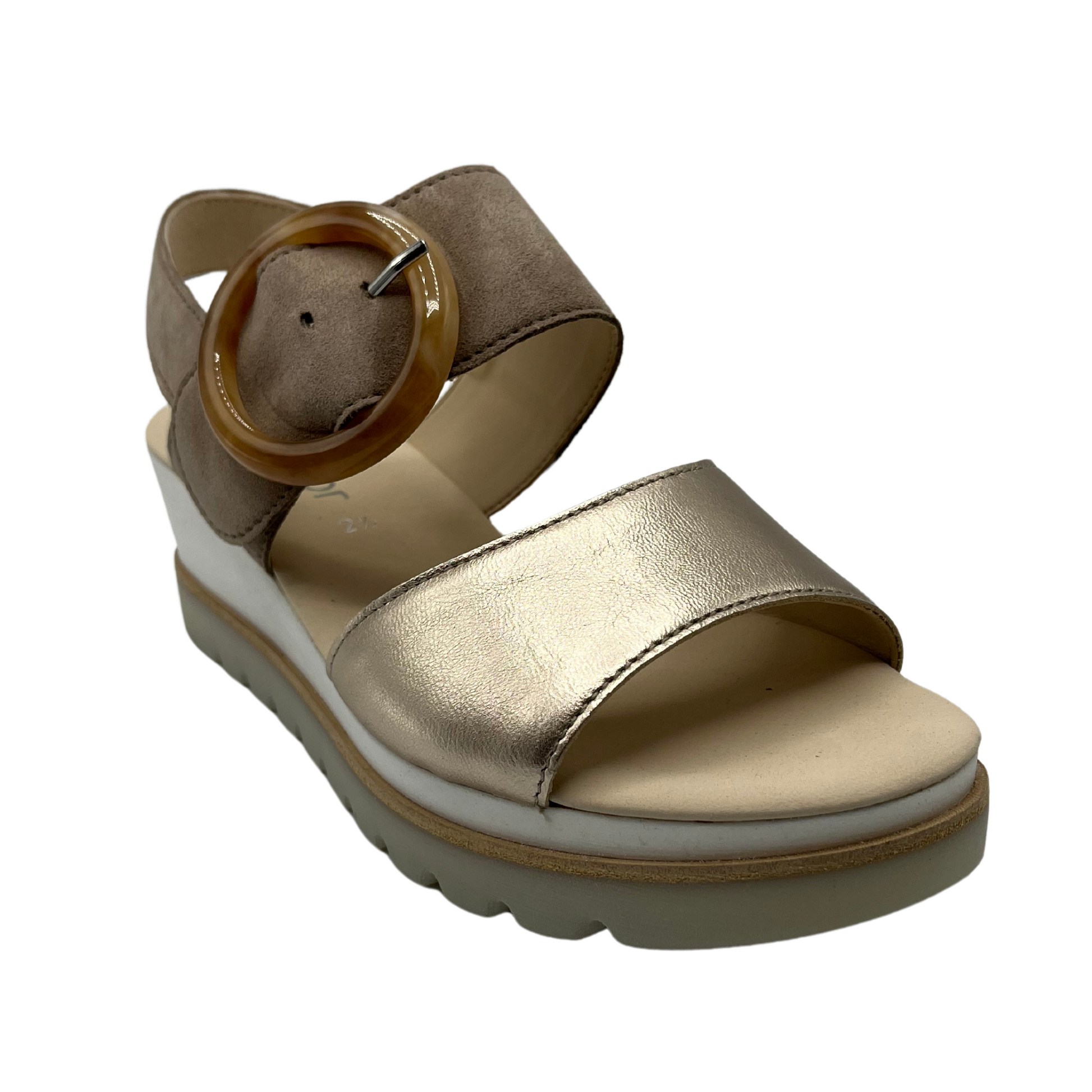 45 degree angled view of taupe and gold sandal with open toe and round buckle on top strap