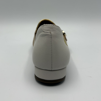 Back view of a beige loafer with buckle strap details