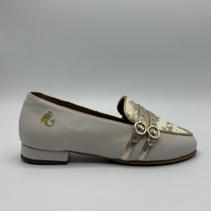 Right facing view of a beige loafer with buckle strap details