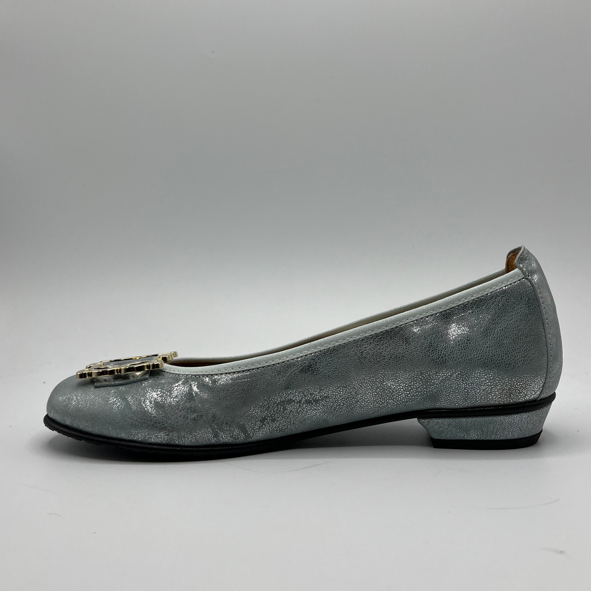 Left facing view of a blue pearl ballet flat with a short wrapped heel, cushioned insole and stretchy upper.