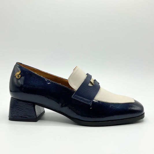 Right facing view of a navy leather loafer with a cream accent panel