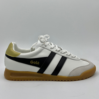 Right facing view of a leather sneaker with a brown rubber outsole and a lace up design.