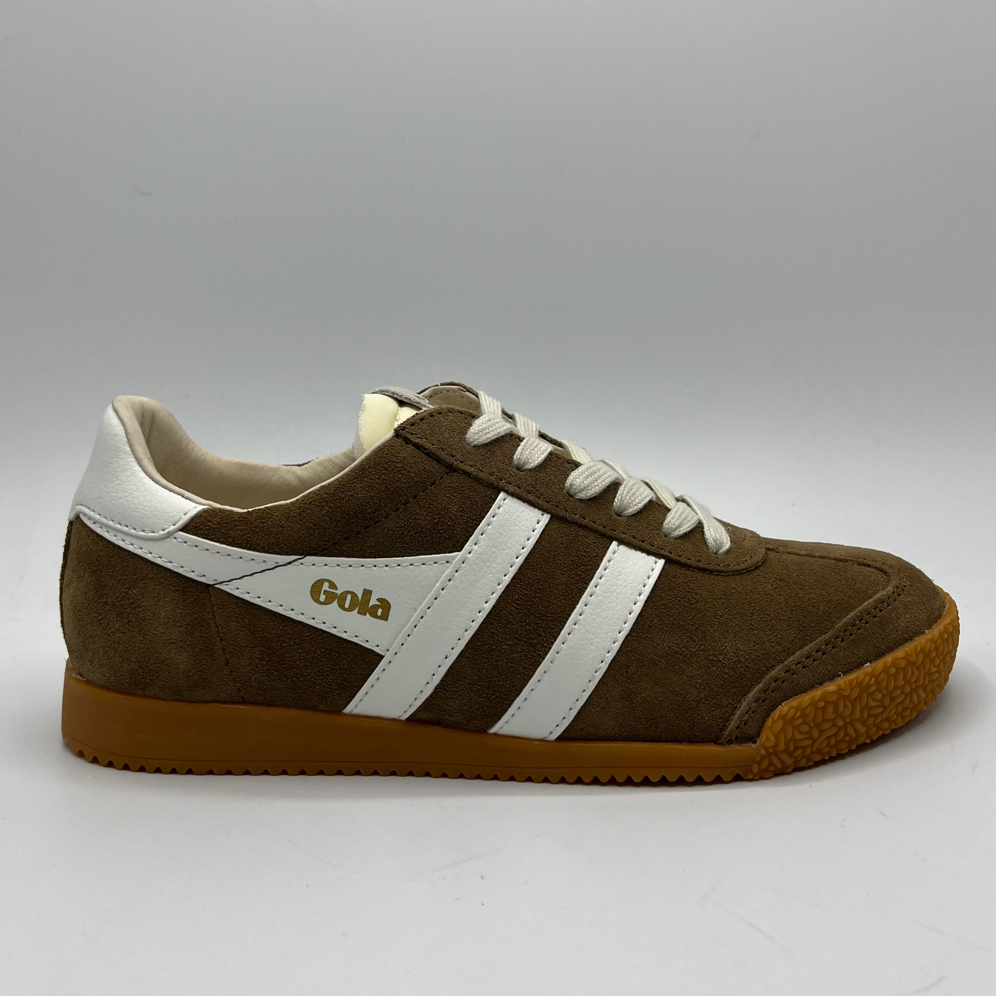 Brown and white sneaker with 'Gola' branding on a gray background