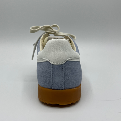 Back view of a blue suede sneaker with white accents, a gum outsole and a lace up design.