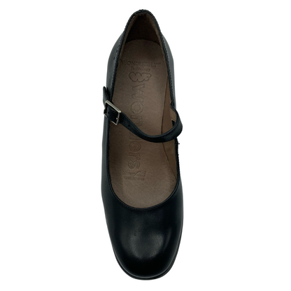 Top down view of rounded Mary Jane shoe with black strap and small silver buckle