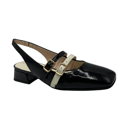 45 degree angled view of black patent leather mary jane with a natural coloured accent strap. Sling back strap, wrapped block heel and square toe