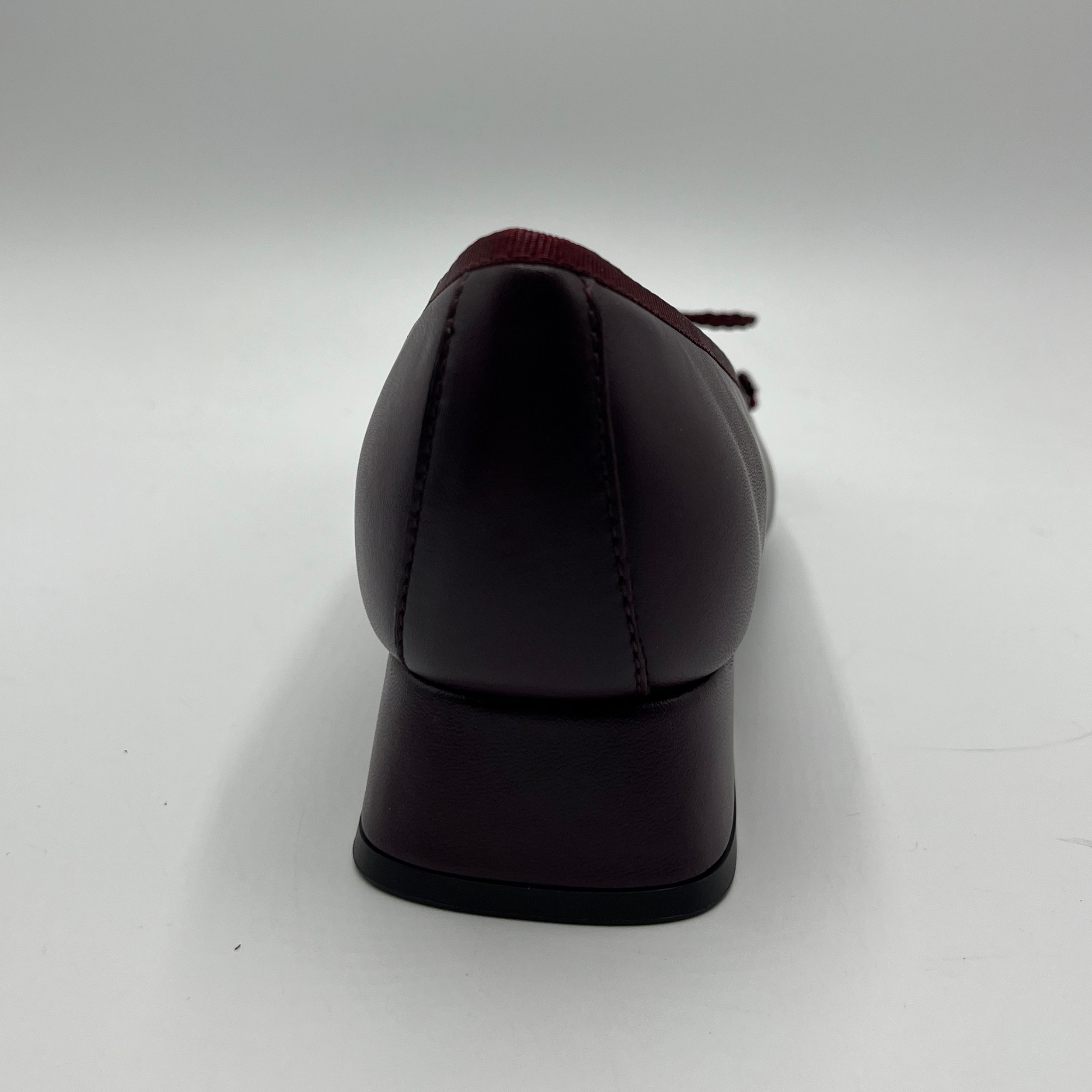 Dark red shoe on a white background