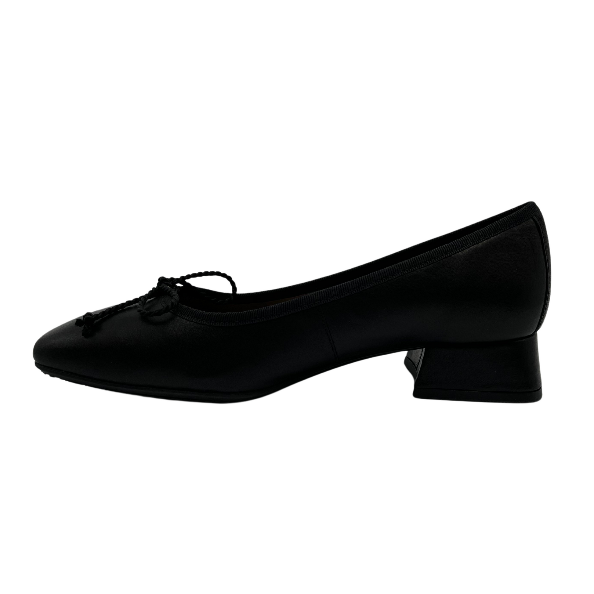 Left facing view of black ballet style pump with short block heel. Bow detail on upper and features a square toe