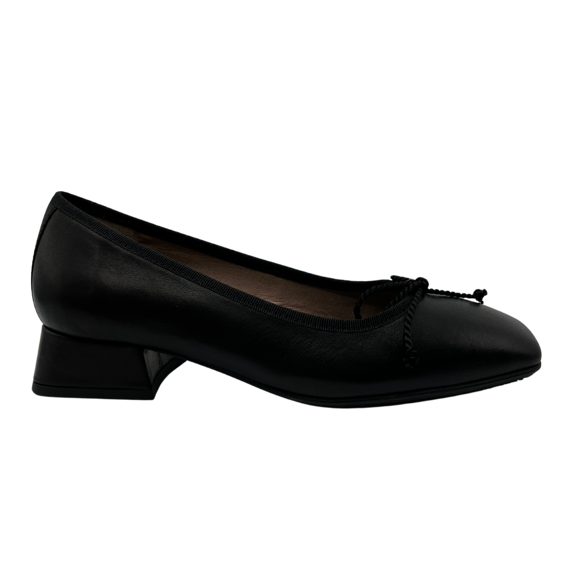 Right facing view of black ballet style pump with short block heel. Bow detail on upper and features a square toe