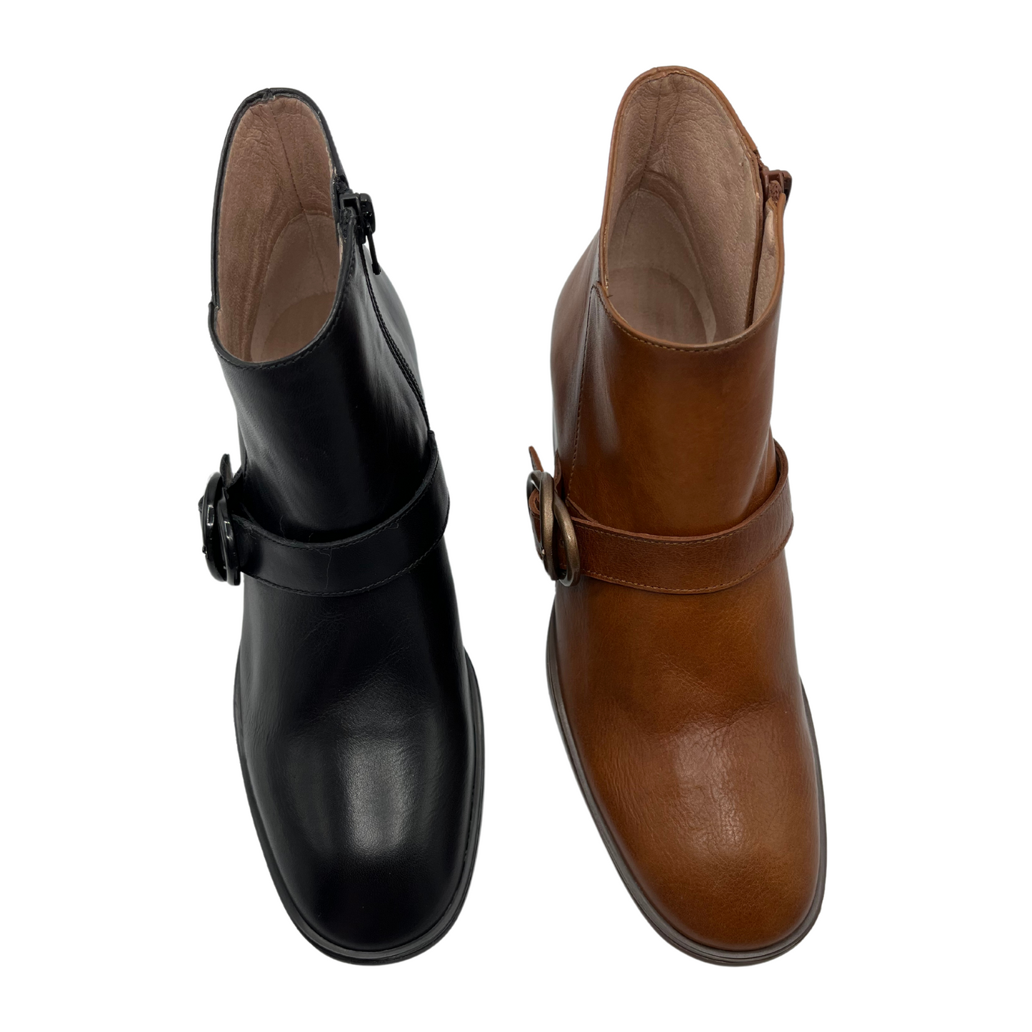 Top view of two short boots beside each other. One is black and one is tan. Both are made of leather with a side zipper and rounded toe